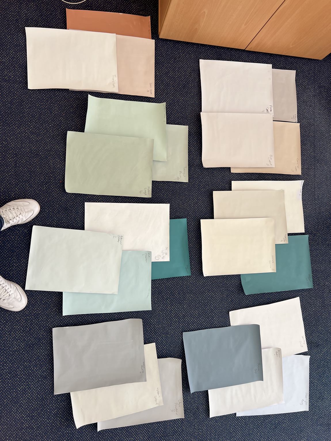 Dozens of paint swatches laid out on the floor