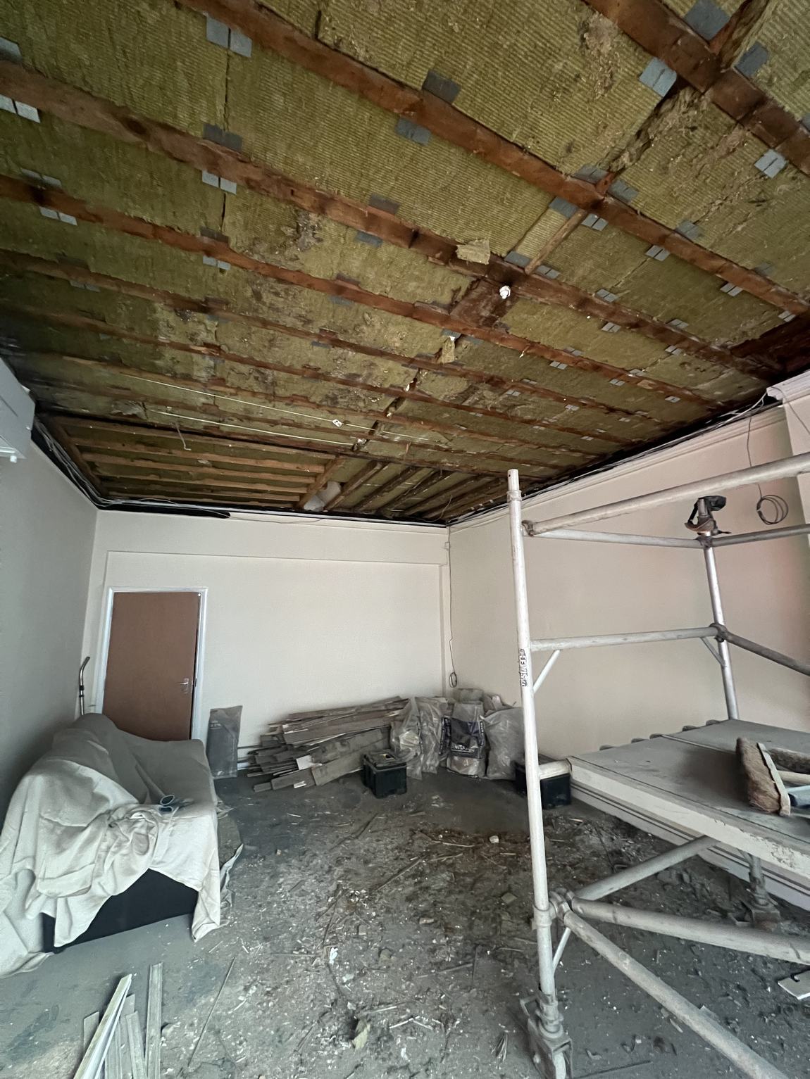 The old ceiling stripped back to joists and insulation