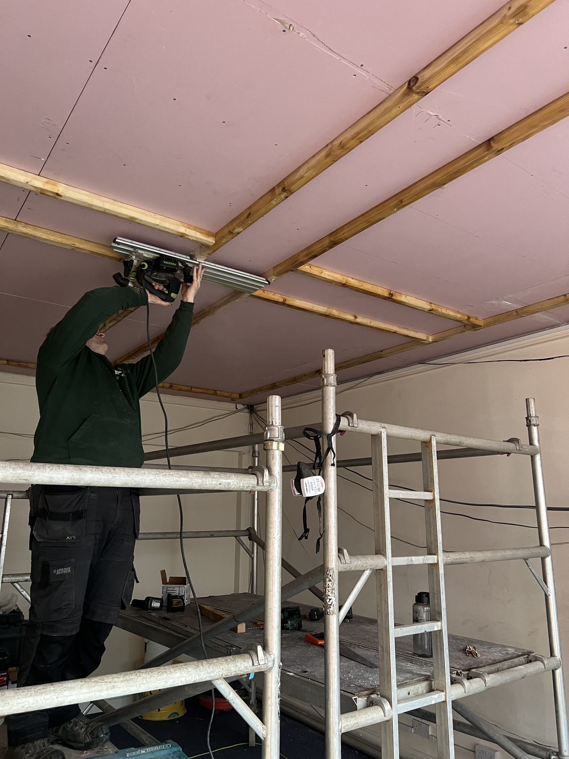 Pink fireproof boards up with timber battens forming coffers