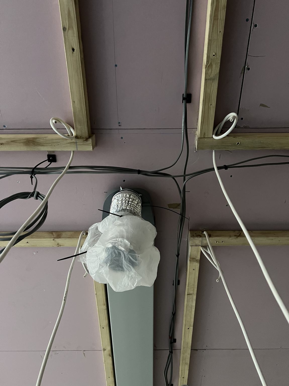 Ventilation ducting threaded around the lighting wiring