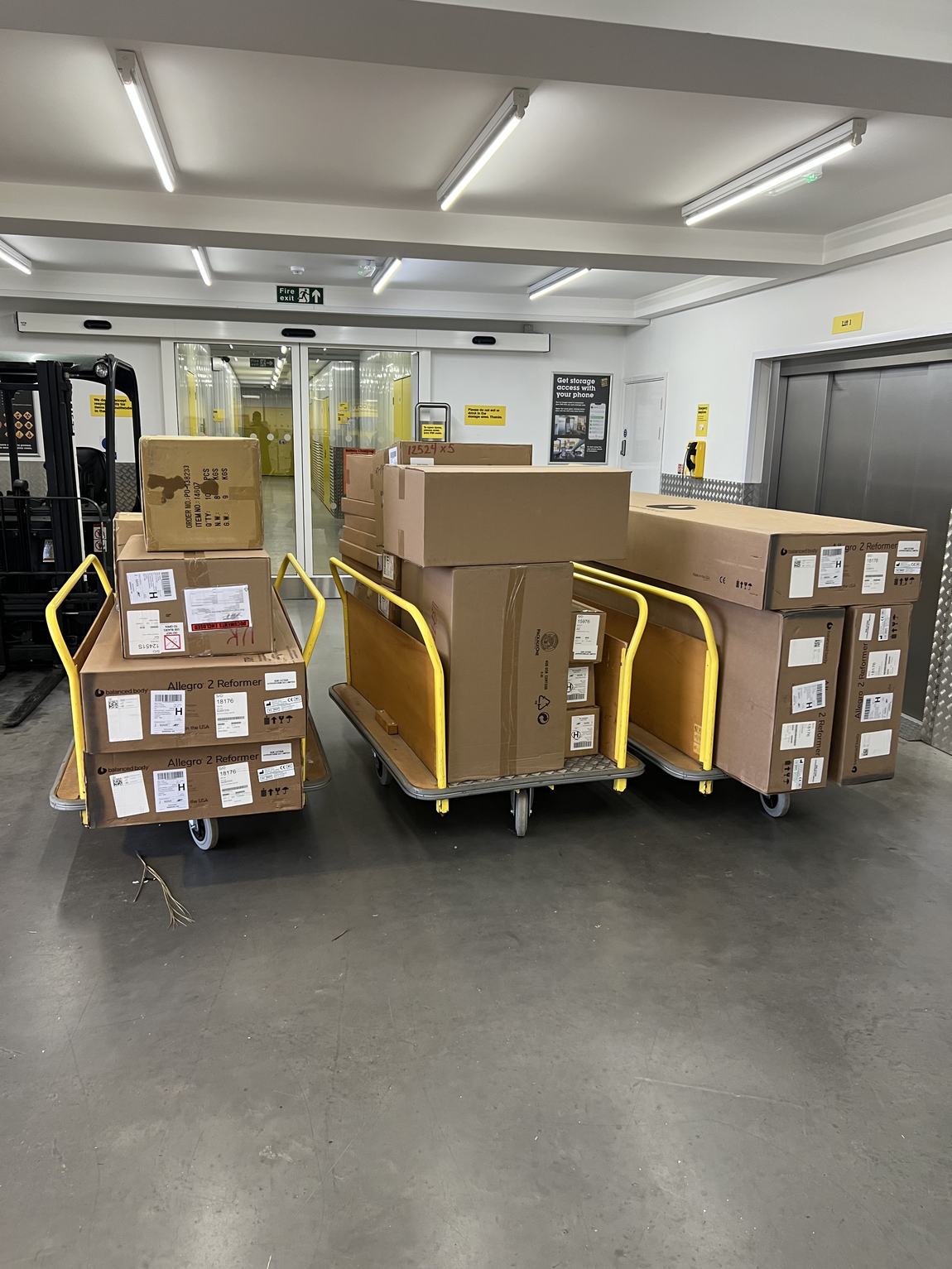 Three trolleys of reformer boxes at the storage centre