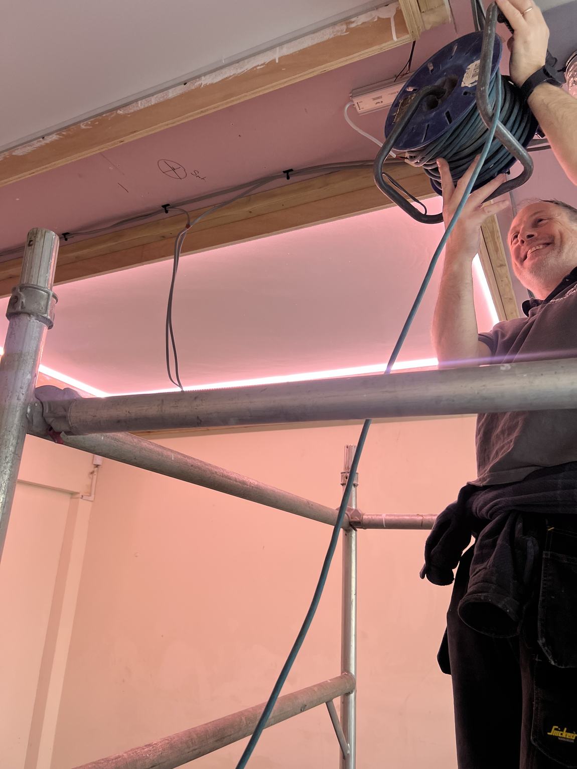 Frazier the electrician on the scaffold as the first LEDs light up