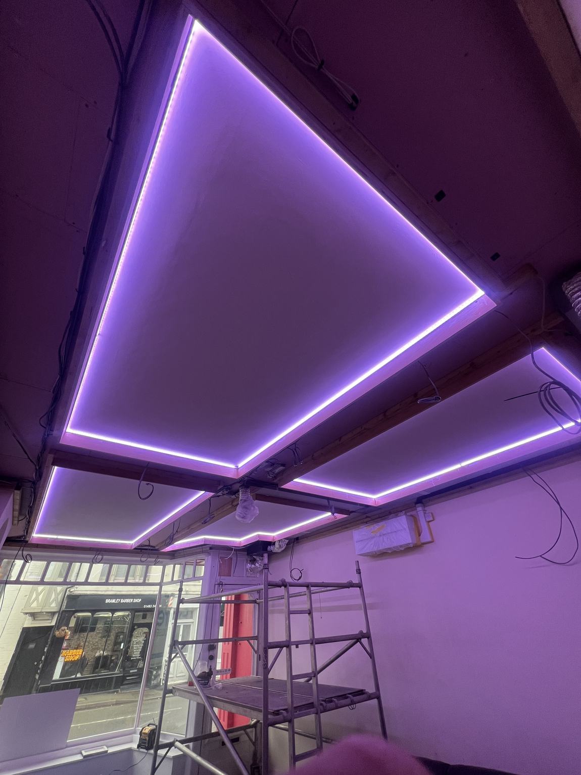 The coffered ceiling lit purple