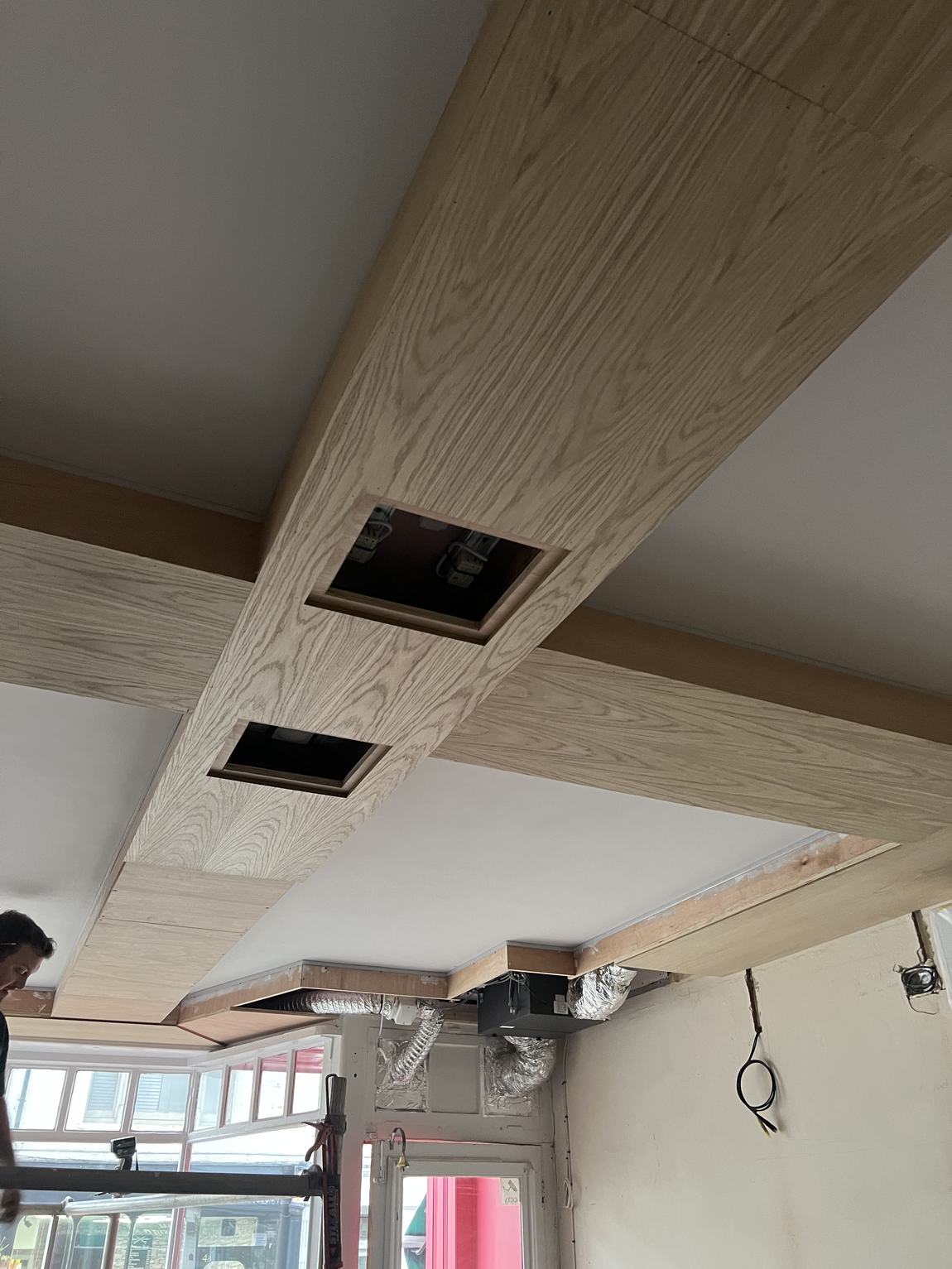The finished oak coffered ceiling with recessed spotlights