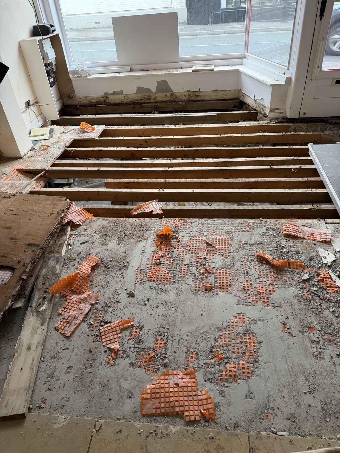 Floorboards lifted near the bay window revealing joists