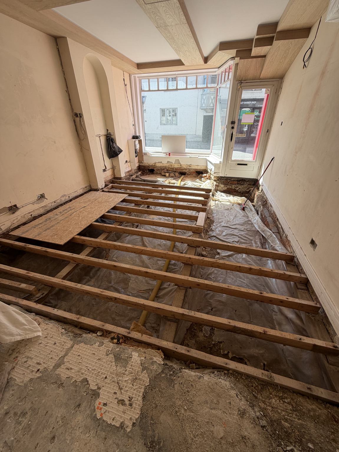 The entire floor lifted, joists exposed across the room