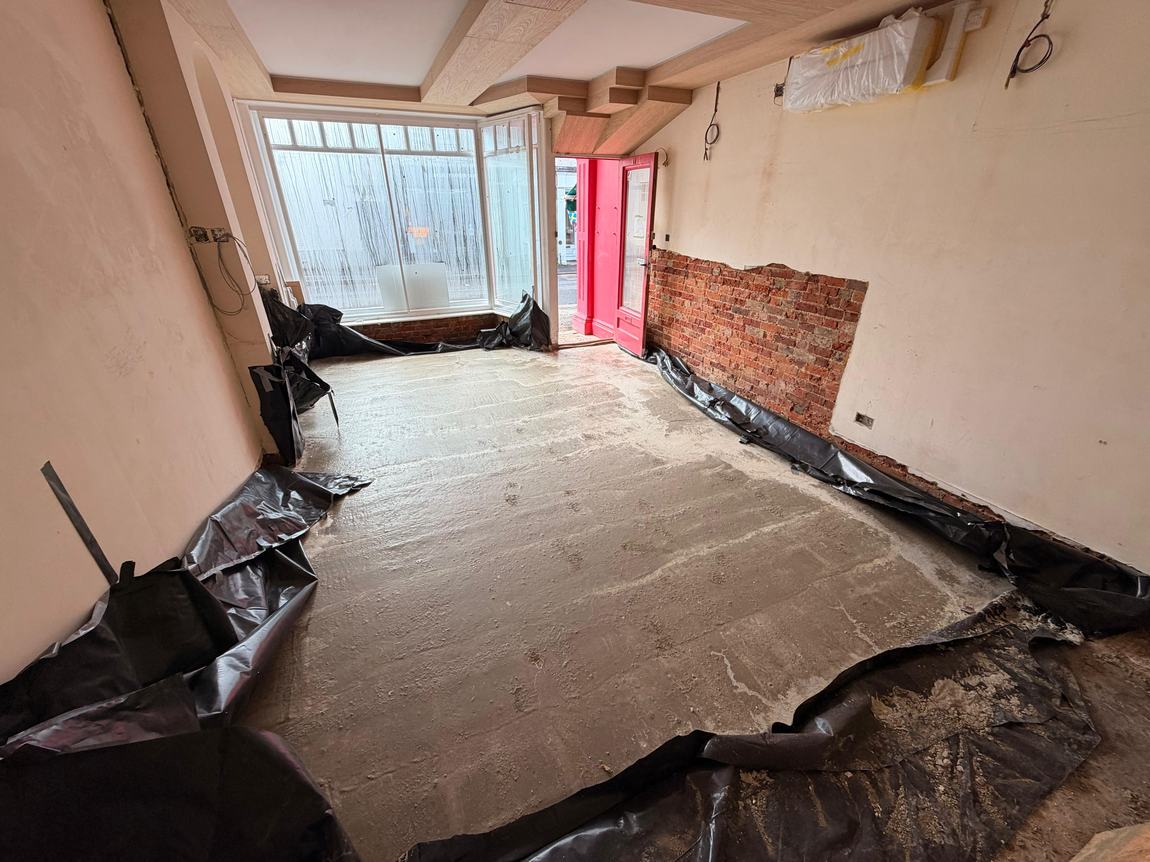 The finished concrete slab poured across the studio floor