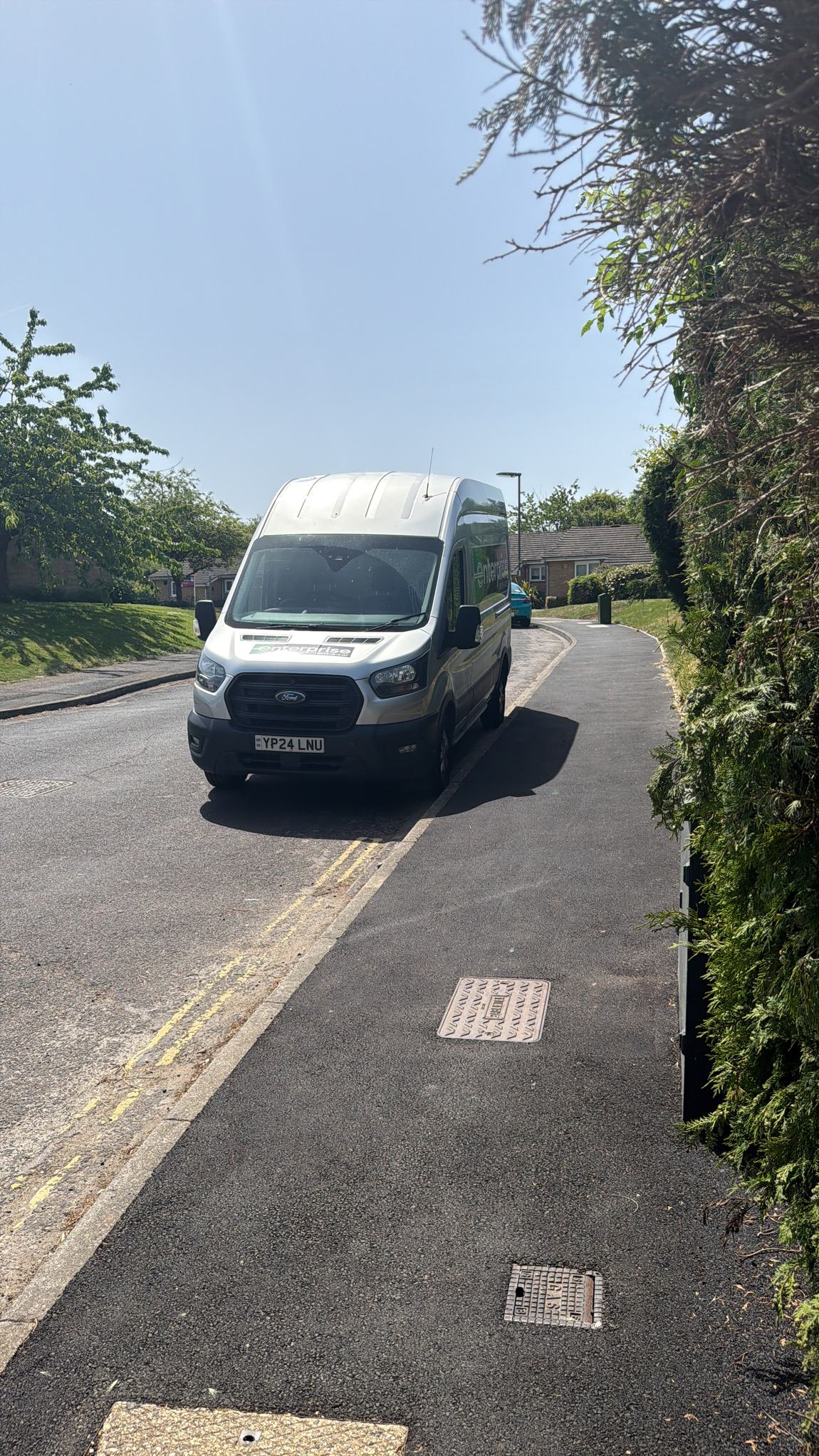 A large hired Enterprise van parked on a residential street